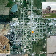 Context: As seen in this satellite photo, the school is located in a rural town. An inset photo shows a devestated building; the town is being rebuilt after a F5 tornado destroyed 95% of the town. - Photo Credit: (c) BNIM