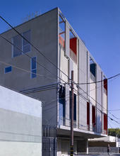 The view from the alley, as seen in the photo, shows shaded balconies and the green roof above. - Photo Credit: John Linden