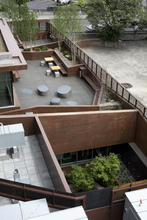 View of landscaped courtyards, featuring stormwater treatment, bioswales, and drought-tolerant native landscaping. - Photo Credit: Sally Schoolmaster