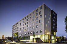 Dusk view of Bud Clark Commons from southwest. - Photo Credit: Christian Columbres