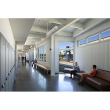 A daylit corridor with views to the courtyard playground can be seen in this photo. - Photo Credit: Credit: (c) Farshid Assassi