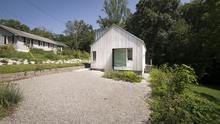 The New Norris House occupies a previously developed infill lot. Walls of the sunken drive court mark the historic home. - Photo Credit: Ken McCown